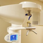 Modern dental X-ray machine with digital display in a clinic.